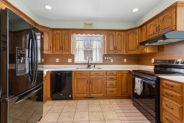 kitchen with sink, backsplash, black appliances, and light tile patterned floors