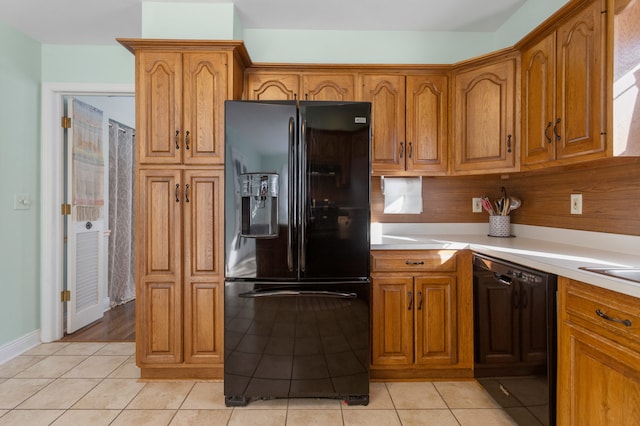 kitchen featuring black appliances and light tile patterned floors