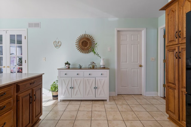 kitchen with light tile patterned floors and french doors