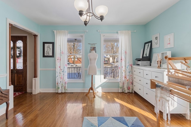 interior space with a notable chandelier and light wood-type flooring