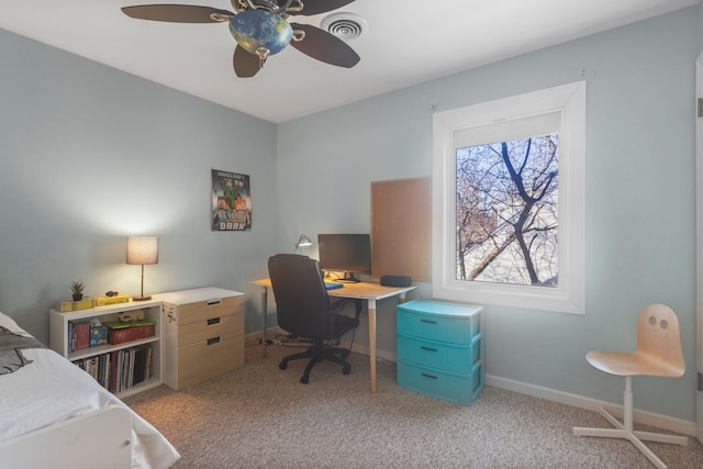 carpeted office with ceiling fan and plenty of natural light