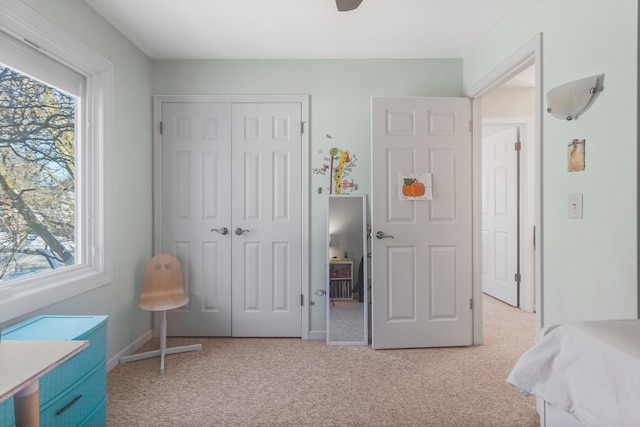 carpeted bedroom with a closet and ceiling fan