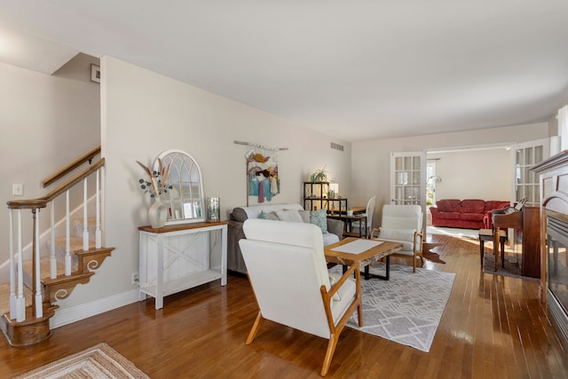 living room with hardwood / wood-style flooring and a healthy amount of sunlight