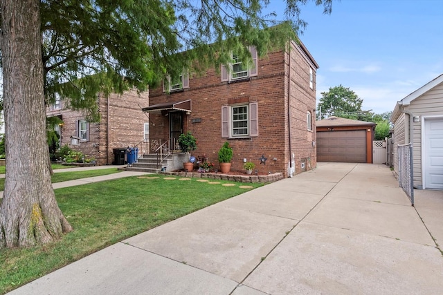 view of front facade with an outbuilding, a garage, and a front yard