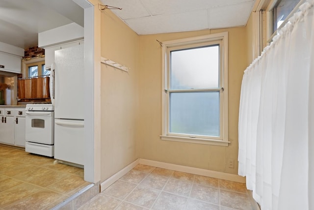 kitchen with a healthy amount of sunlight and white appliances