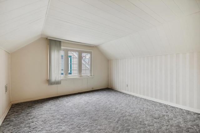 additional living space featuring carpet and lofted ceiling