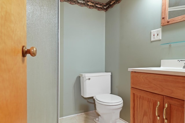 bathroom featuring tile patterned flooring, vanity, and toilet