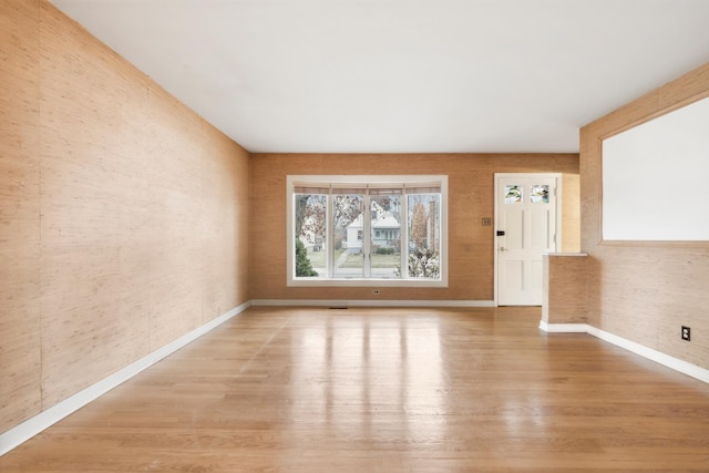 empty room with hardwood / wood-style floors