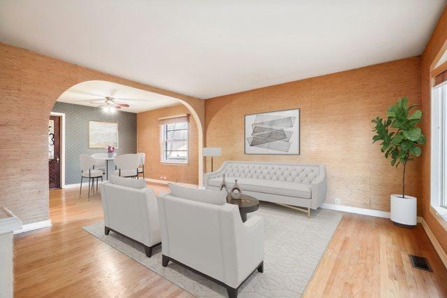 living room featuring ceiling fan and light hardwood / wood-style floors