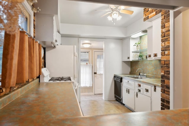 kitchen with white appliances, white cabinets, sink, ceiling fan, and decorative backsplash