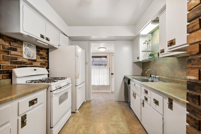 kitchen featuring backsplash, stainless steel dishwasher, white range with gas cooktop, sink, and white cabinets