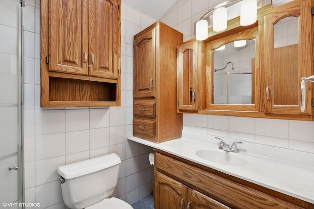 bathroom with toilet, a shower with door, decorative backsplash, tile walls, and vanity