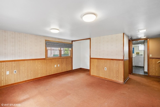 empty room featuring carpet and washer / dryer