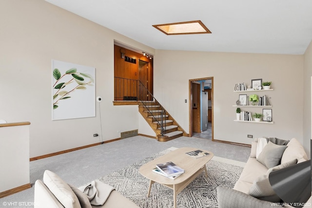 living room with light colored carpet and lofted ceiling with skylight