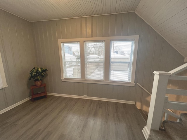 additional living space with a wealth of natural light, dark hardwood / wood-style flooring, lofted ceiling, and wood ceiling