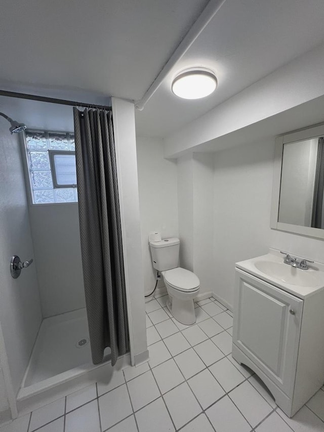 bathroom with toilet, tile patterned floors, vanity, and curtained shower