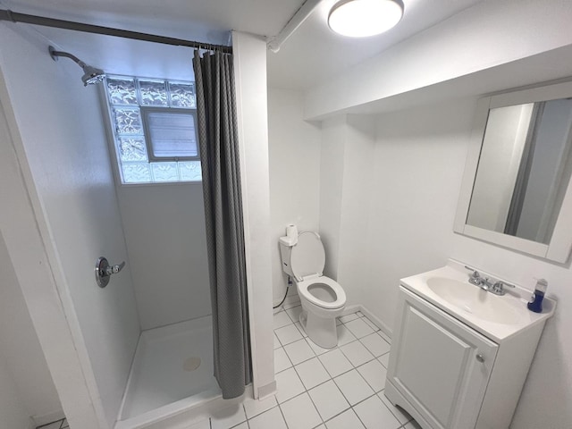 bathroom with toilet, tile patterned floors, vanity, and curtained shower