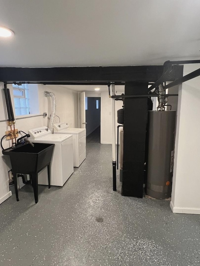 basement featuring sink, washing machine and dryer, and water heater