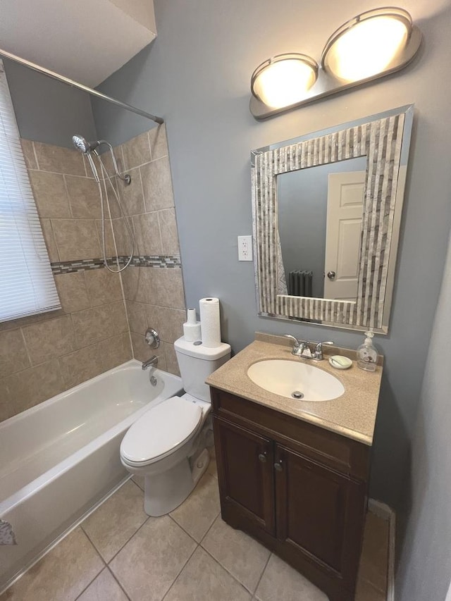 full bathroom featuring toilet, vanity, tile patterned floors, and tiled shower / bath