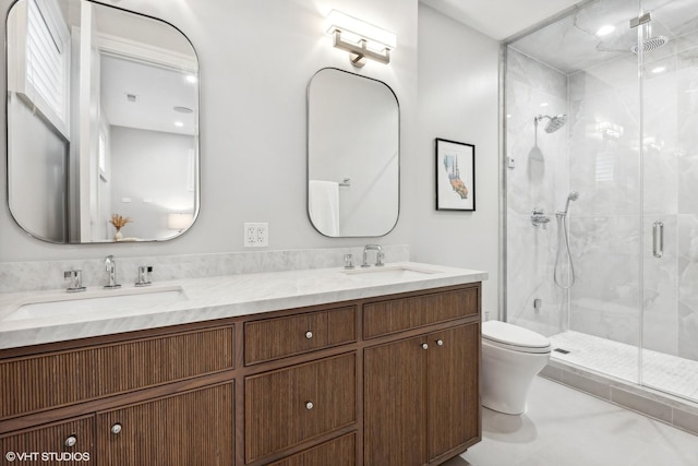 bathroom with vanity, toilet, and a shower with door