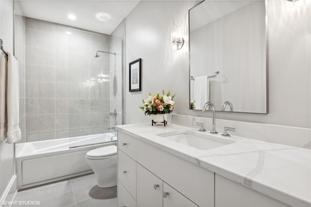 full bathroom featuring tile patterned flooring, tiled shower / bath combo, toilet, and vanity