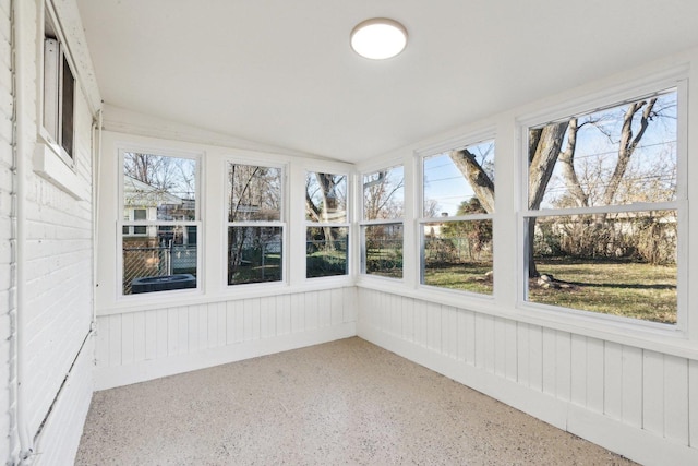 unfurnished sunroom featuring plenty of natural light and lofted ceiling