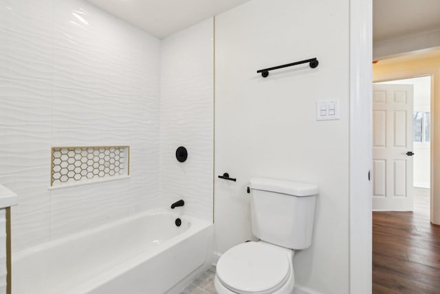 bathroom with hardwood / wood-style flooring, toilet, and tub / shower combination