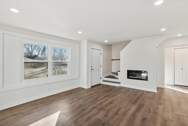 unfurnished living room with dark hardwood / wood-style floors