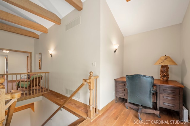 office with lofted ceiling with beams and light hardwood / wood-style flooring