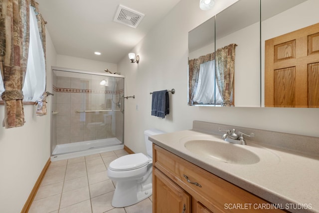 bathroom featuring toilet, tile patterned flooring, vanity, and a shower with shower door