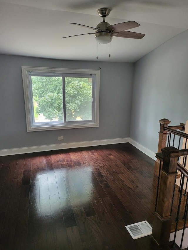 spare room with ceiling fan and dark wood-type flooring