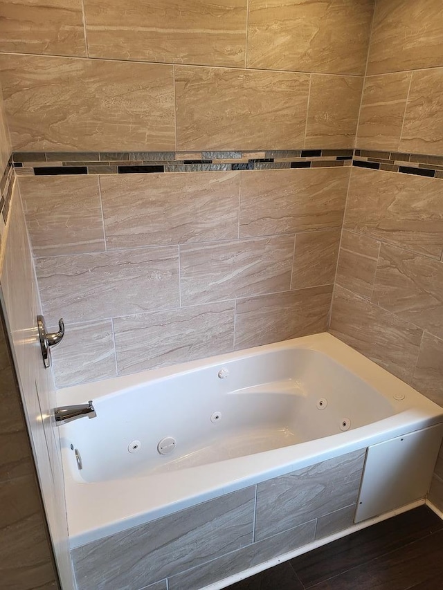 bathroom featuring a relaxing tiled tub