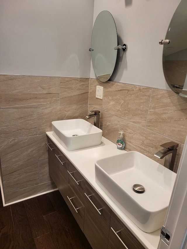 bathroom featuring hardwood / wood-style floors, vanity, and tile walls