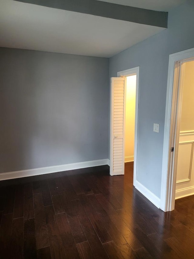 spare room with dark hardwood / wood-style flooring