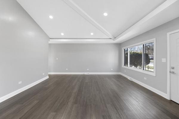 unfurnished living room featuring dark wood-type flooring and vaulted ceiling