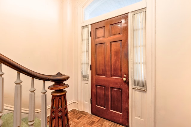 foyer entrance with light parquet flooring