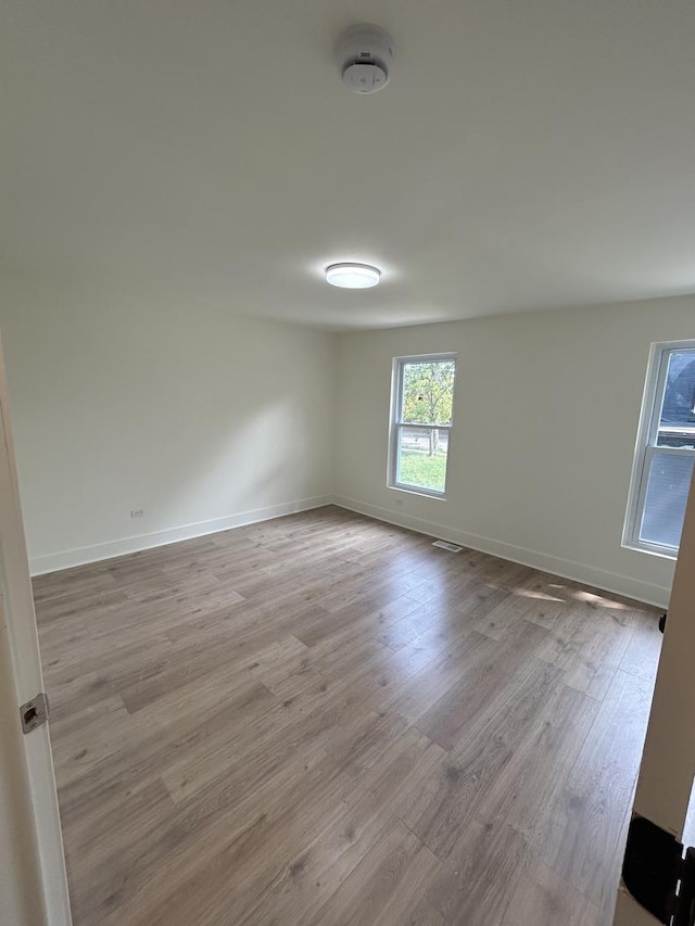 unfurnished room with light hardwood / wood-style floors