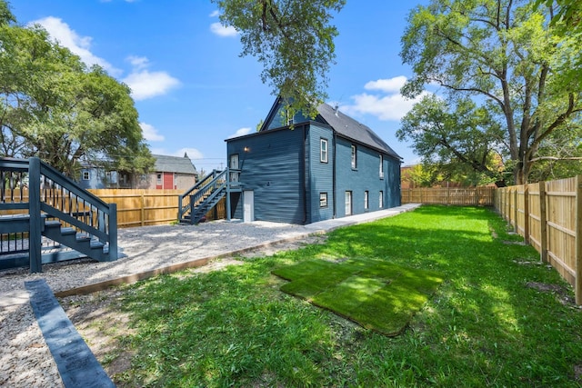 rear view of house with a lawn