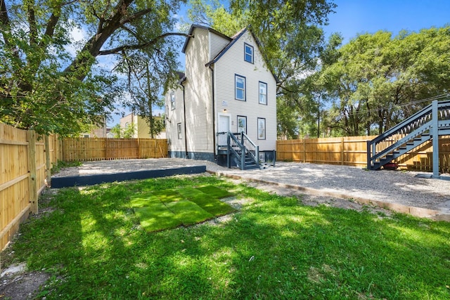 rear view of house with a lawn