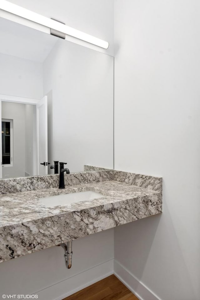 bathroom with wood-type flooring and sink