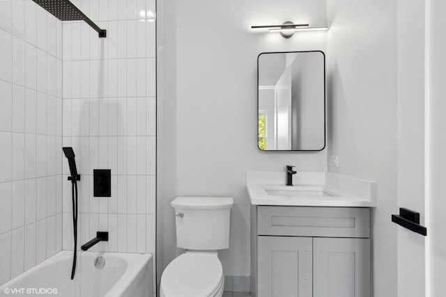 full bathroom featuring tiled shower / bath combo, toilet, and vanity