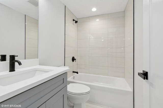 full bathroom with vanity, toilet, and tiled shower / bath