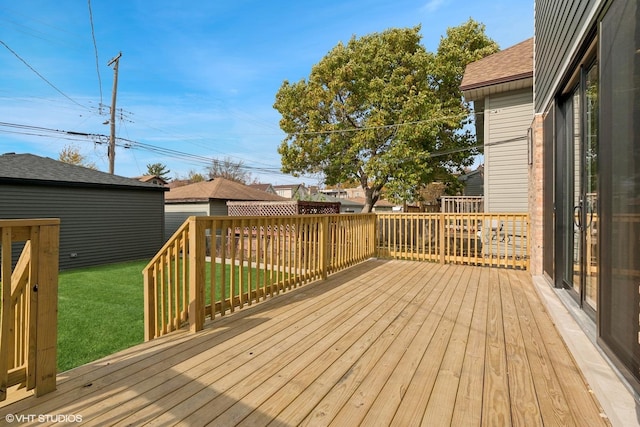 wooden terrace with a lawn