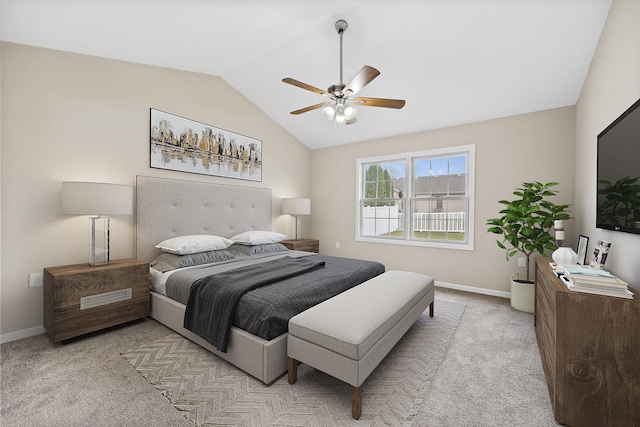 bedroom with ceiling fan, light carpet, and vaulted ceiling