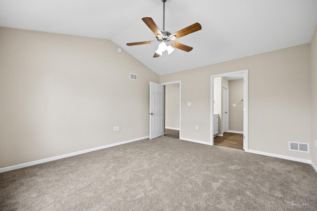 unfurnished bedroom featuring ceiling fan, dark carpet, and lofted ceiling