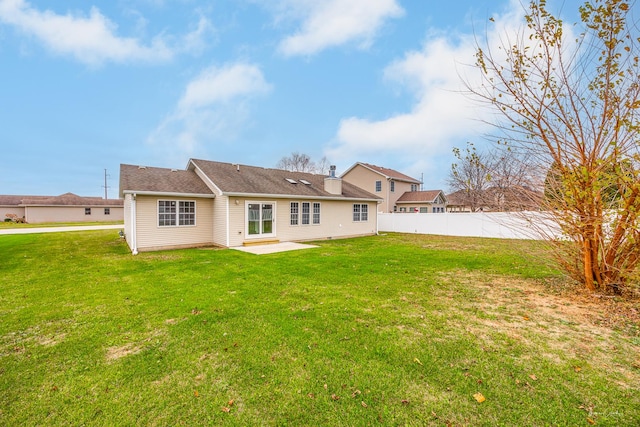 back of house featuring a yard and a patio