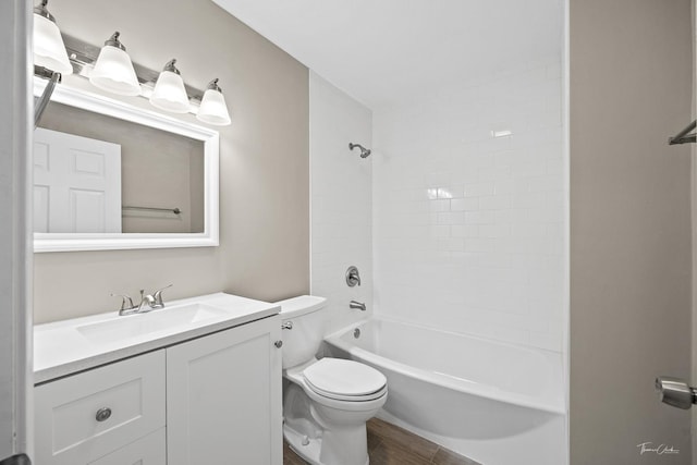 full bathroom with wood-type flooring, vanity, toilet, and tiled shower / bath combo