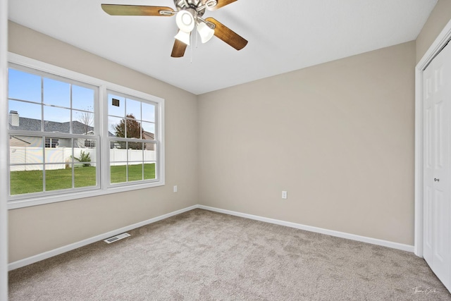 carpeted empty room with ceiling fan