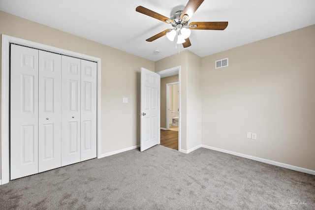 unfurnished bedroom with carpet, ceiling fan, and a closet