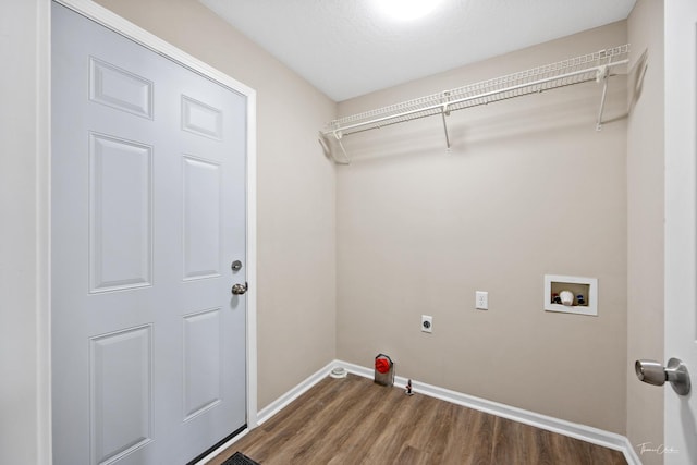 clothes washing area featuring hookup for an electric dryer, washer hookup, a textured ceiling, and dark hardwood / wood-style floors